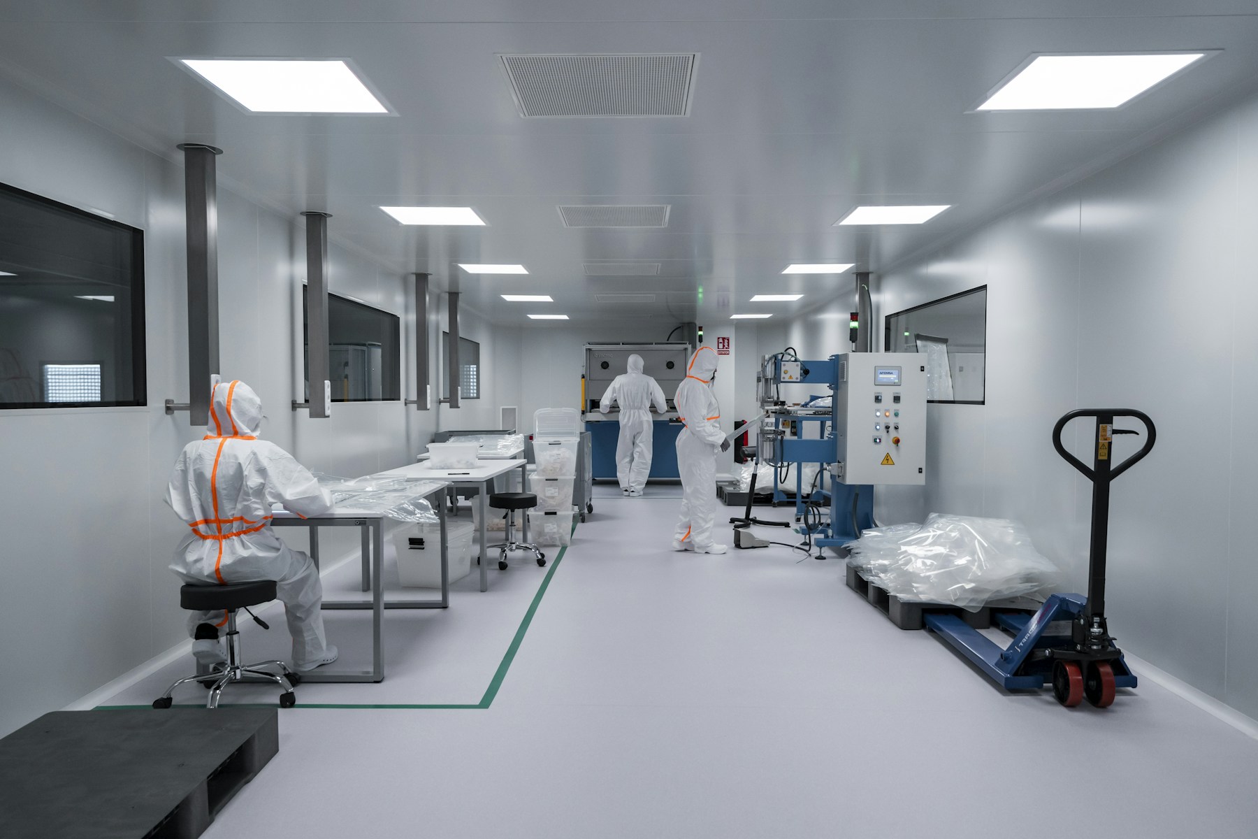 Specialists working in a controlled cleanroom production environment